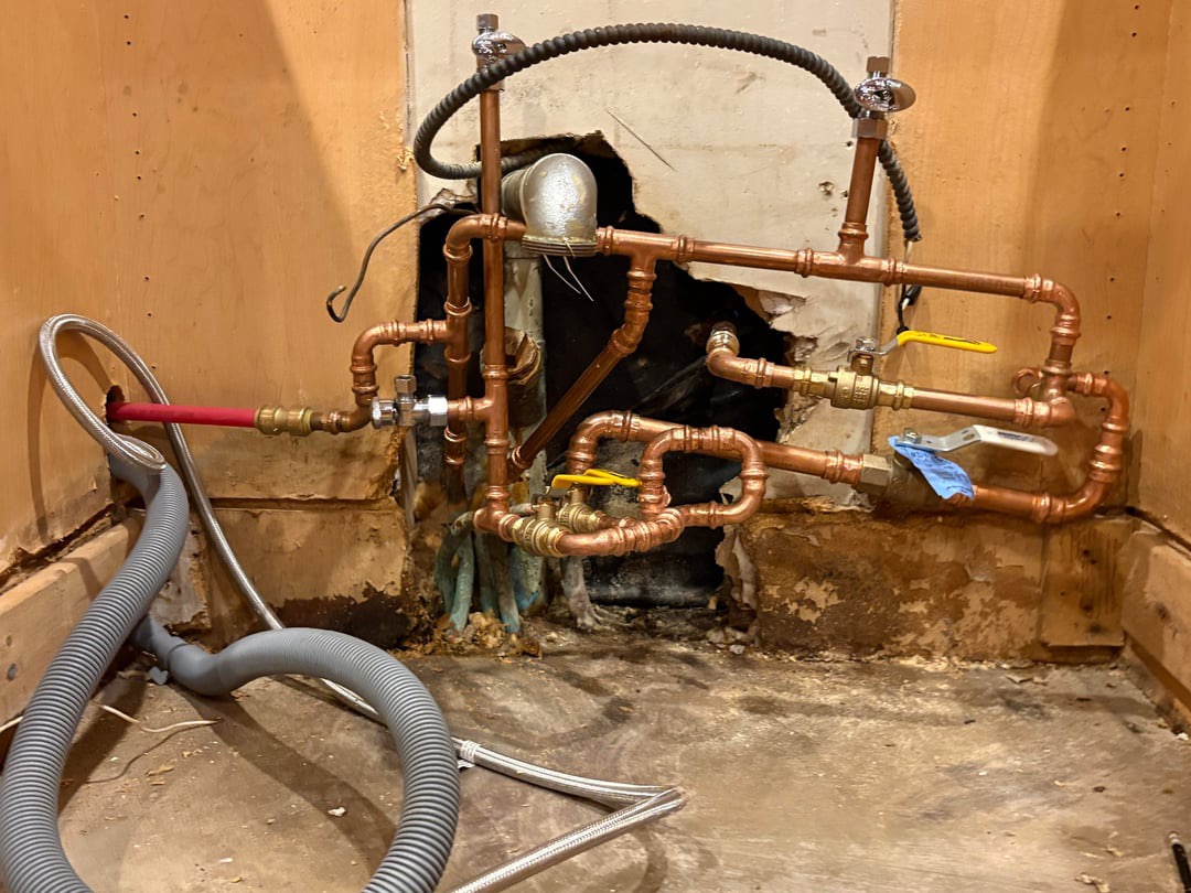 A tangled patchwork of plumbing pipes
